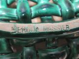 a close up of a green vase with writing on it