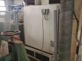 an image of a refrigerator in a room with a lot of pipes