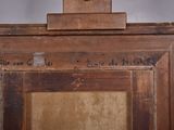 an old picture of a wooden frame with a painting on it