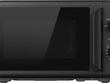 the black microwave oven is on a white surface