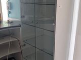 a white cabinet with glass doors in the corner of a room