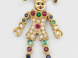 une broche en forme de clown en or et diamants, ornée de pierres multicolores