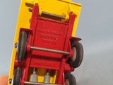 a person holding a toy truck in their hand