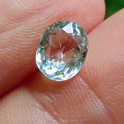 a close up of a person ' s hand holding a gemstone
