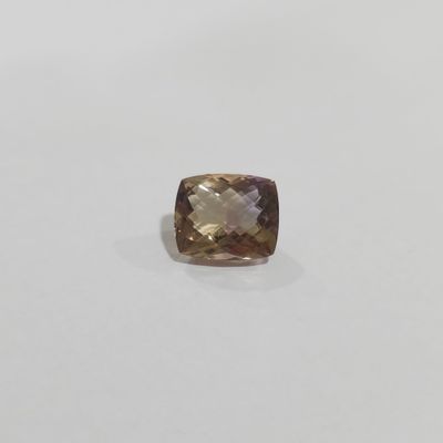 a cushion cut smokyite gemstone on a white surface