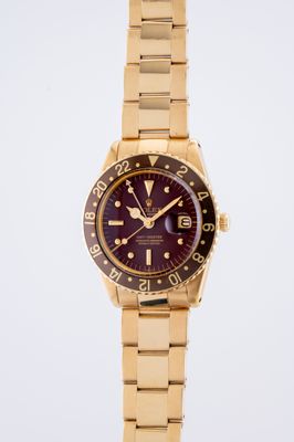 an image of a gold wrist watch with a purple dial