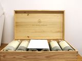 a wooden box with four rolls of rolled up towels in it