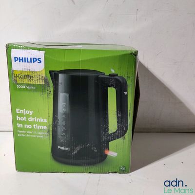 packaging of a black electric kettle sitting on top of a white table