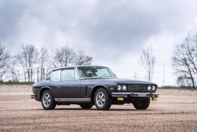 an image of a classic car parked in a field