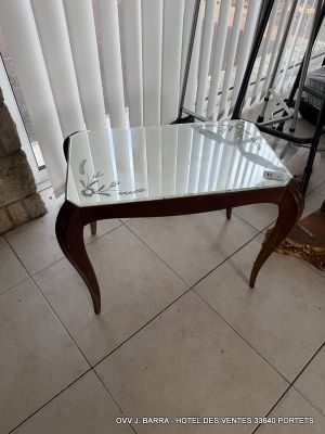 a table with a glass top sitting in front of a window