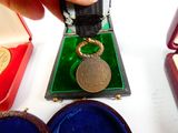 a person that is holding a medal in their hand