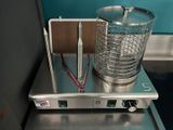 a metal container with a wire basket on top of it