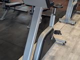 a row of exercise machines in a gym room