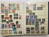 a book with stamps on the pages and a picture of a woman