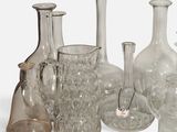 a lot of glass vases that are sitting on a table