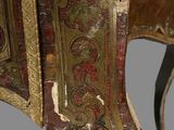 close up of a wooden table with a painted design on the top of it