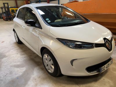 a white car parked in a garage with a boat in the background