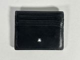 black leather card case with a silver logo on the front