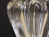 a glass vase sitting on a table with a black background