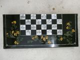 a black and white checkerboard with yellow flowers on it