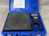a blue case holds a digital scale and a receipt