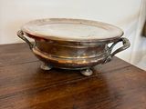 a silver bowl sitting on a wooden table