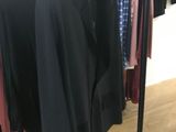 a lot of clothes hanging on a rack in a store