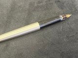 a pen that is laying on the ground next to a pen