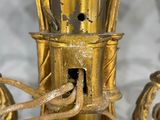 an image of a gold colored candle holder on a white table
