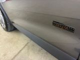 a close up of a car ' s door handle with a sticker on it