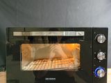 a black toaster oven sitting on top of a wooden counter