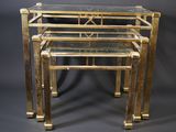 a set of three brass and glass nesting tables