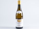 a bottle of white wine sitting on top of a white table