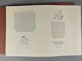 an open book with a drawing of a man and a dog on it