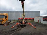 a crane that is sitting in the middle of a parking lot