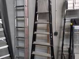 several ladders are lined up in a room with a ladder on one side and a ladder on the other side