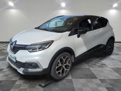a white car parked on a checkered floor in a garage