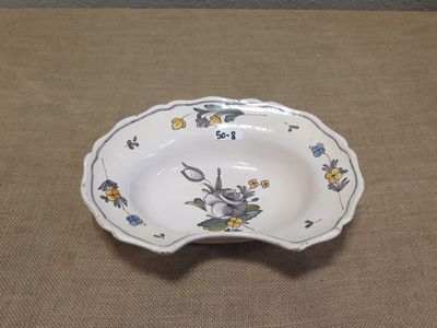 a small bowl with a rabbit on it sitting on a table