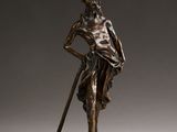 bronze statue of a man with a cane and a hat on his head