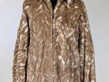 a close up of a fur coat on a mannequin stand