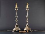 a pair of silver candles are sitting on a table
