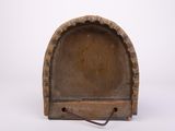 an old wooden bookend with a small hole in the middle of it