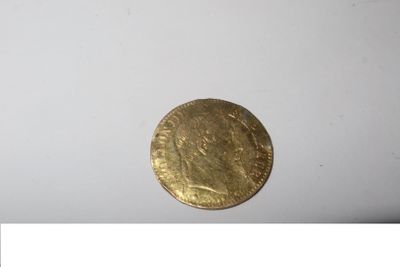 a close up of a gold coin on a white surface