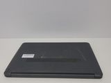the back of a laptop computer sitting on top of a white table