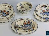 six pieces of blue and white dinnerware with flowers on them