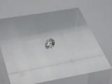 a close up of a piece of silver foil sitting on top of a white table