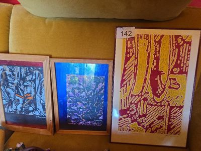 three framed pictures on a couch next to a pillow