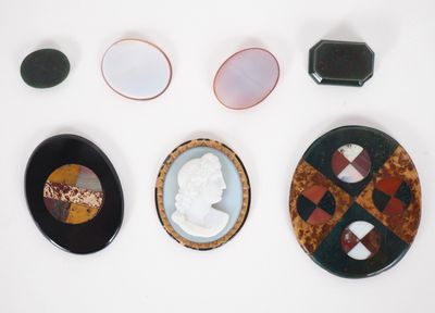 several pieces of art are displayed on a white surface
