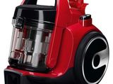 a close up of a red and black vacuum cleaner on a white background