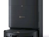 a close up of a black coffee machine on a white surface
